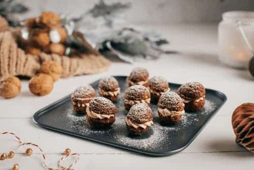 Orechy plnené krémom z vanilkového pudingu, mliečnej čokolády a orechovej pasty na plechu.